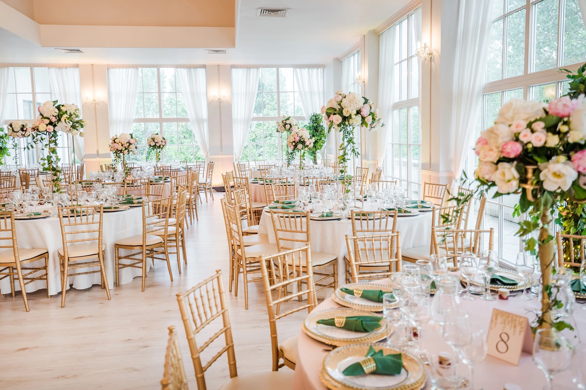 A peach color wedding hall, with tables ready for guests.