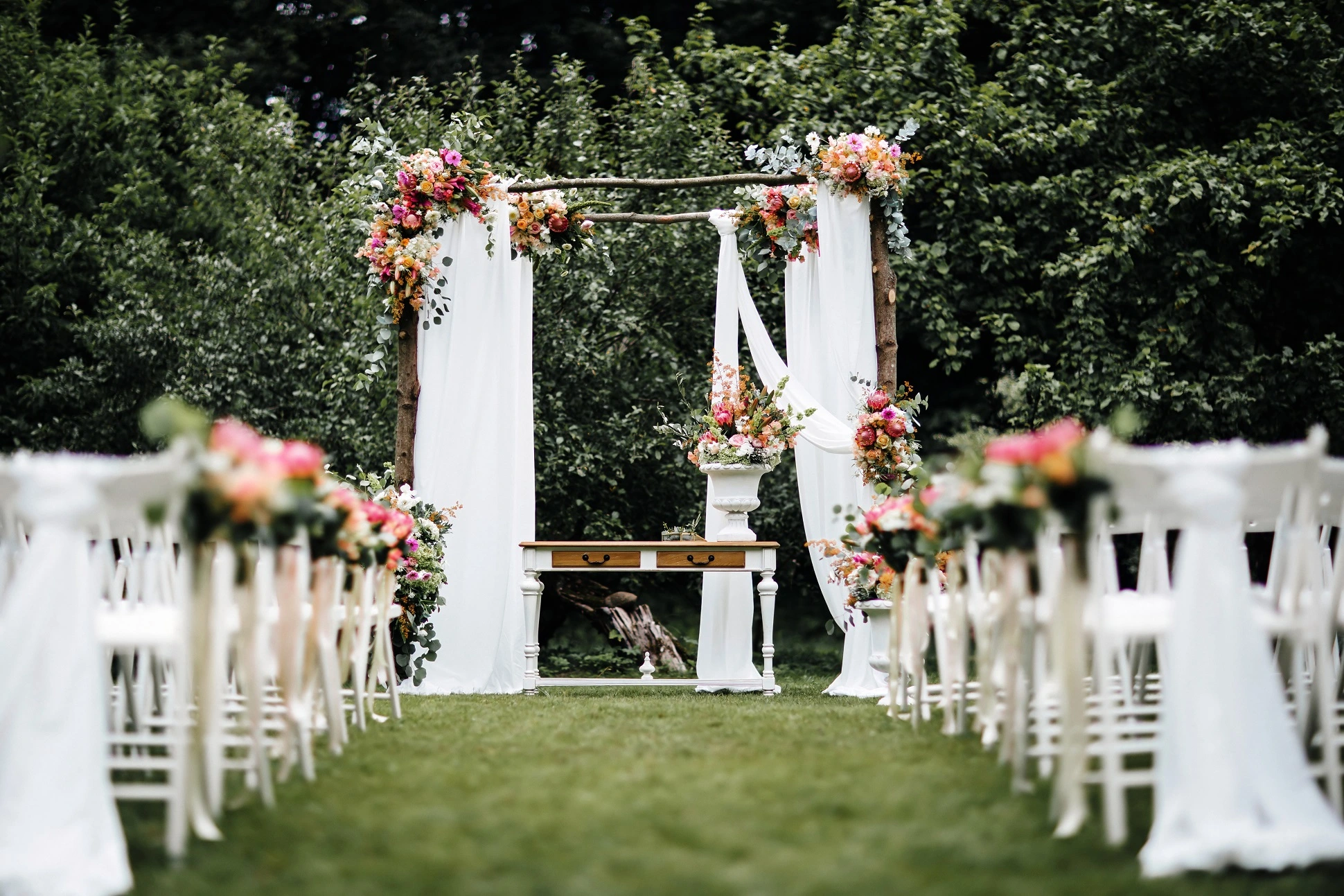 A patio with rows of tables neatly dressed.