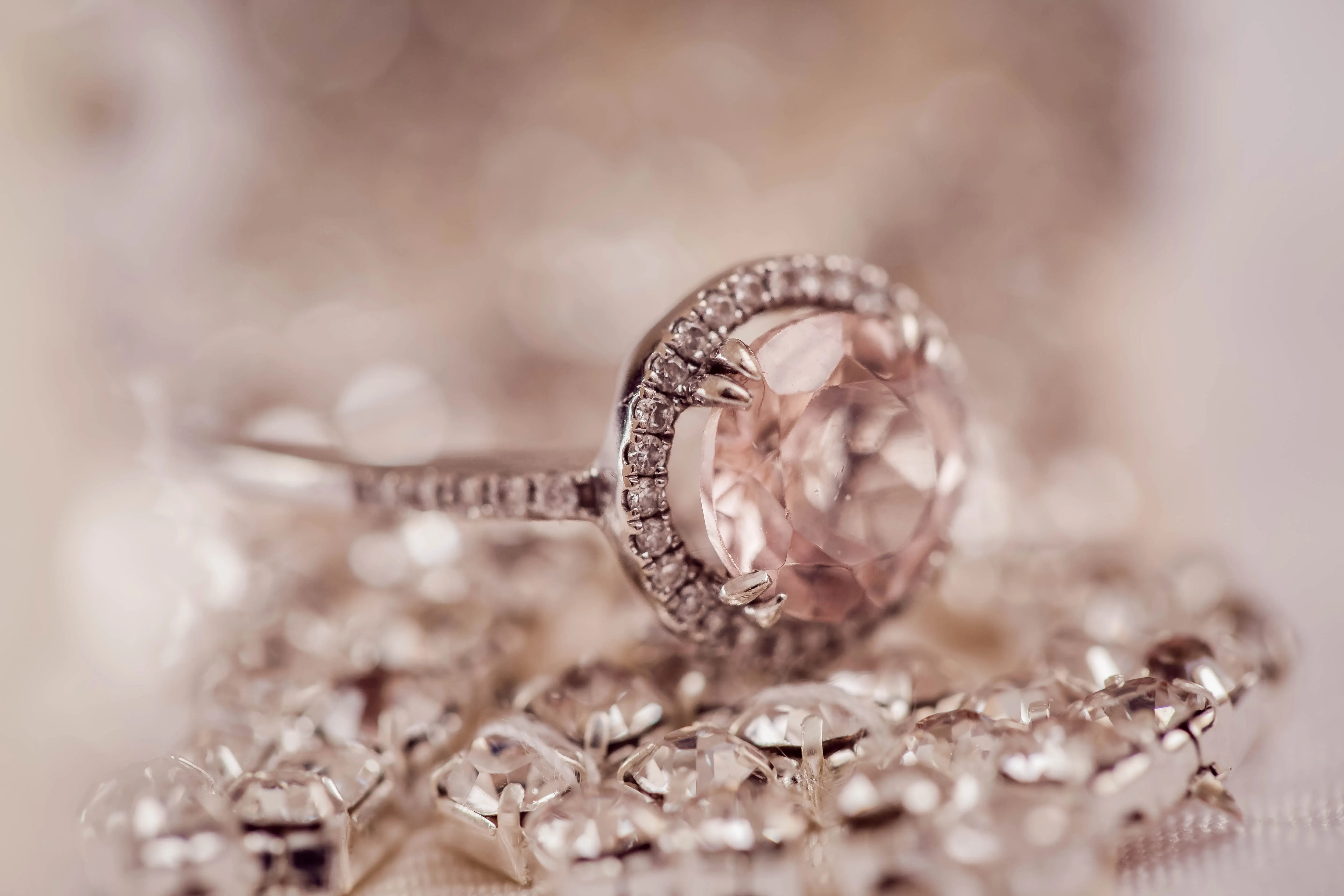 A closeup of a pink diamond wedding ring with a rose-quartz band