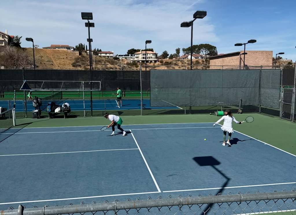 Guests enjoying tennis court